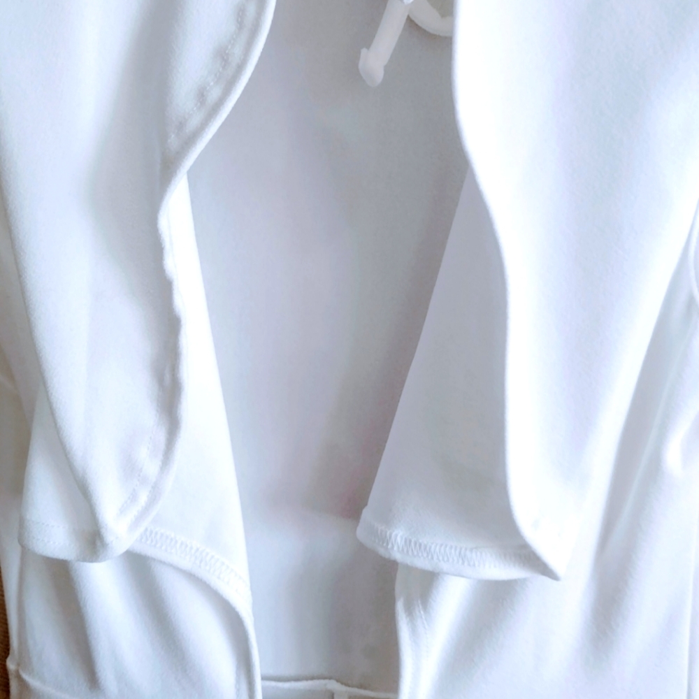 Brand new, white, jumpsuit with back out.
